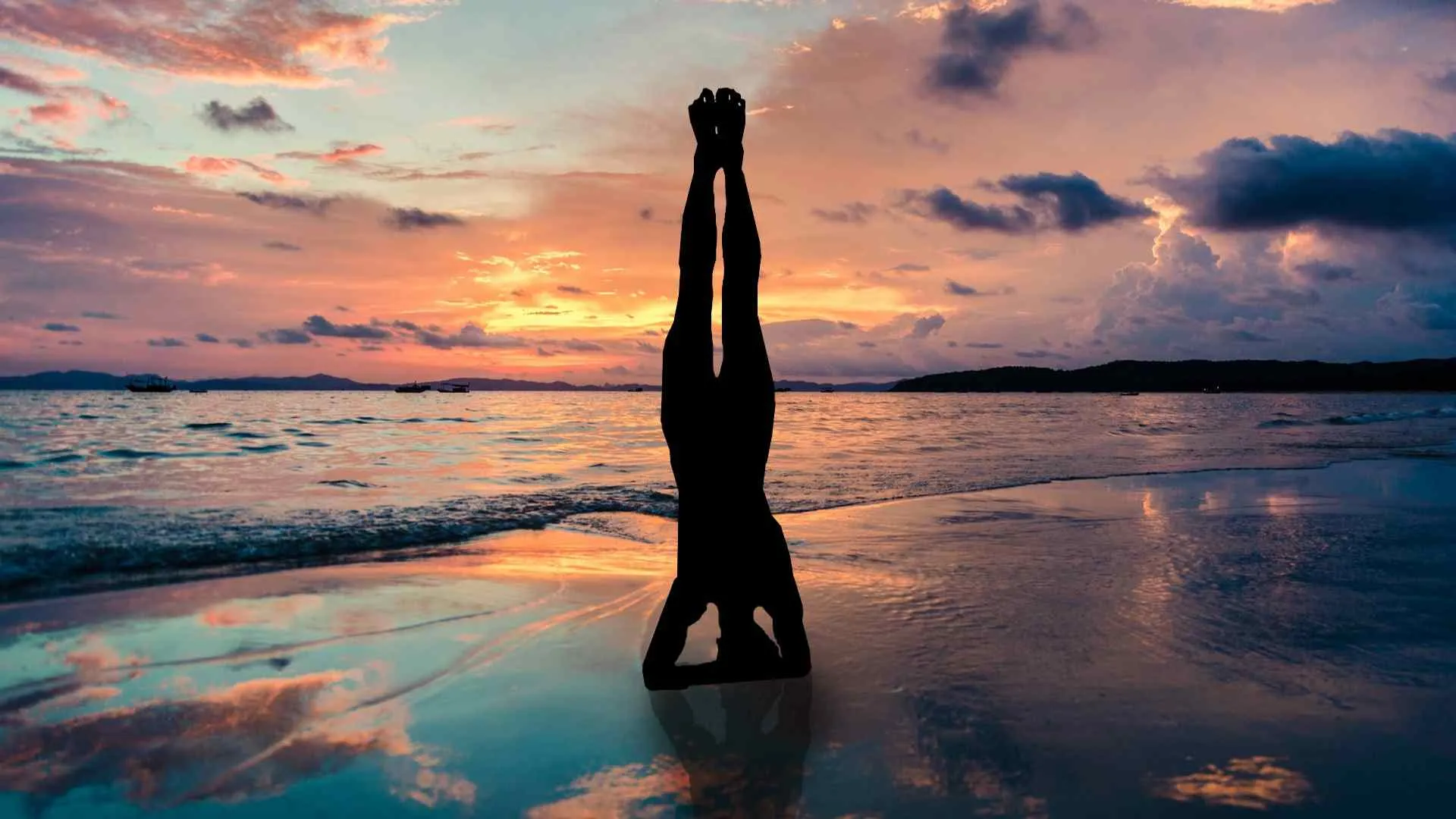 girl doing yoga on beach during sunset